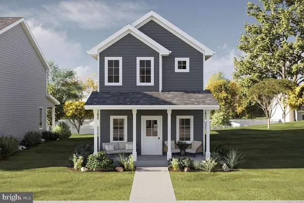 a front view of a house with yard and green space