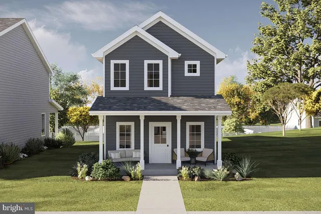 a front view of a house with yard and green space
