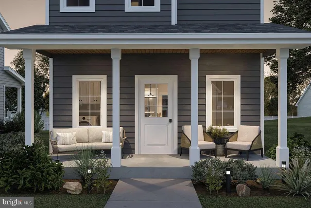 a front view of a house with outdoor seating and porch