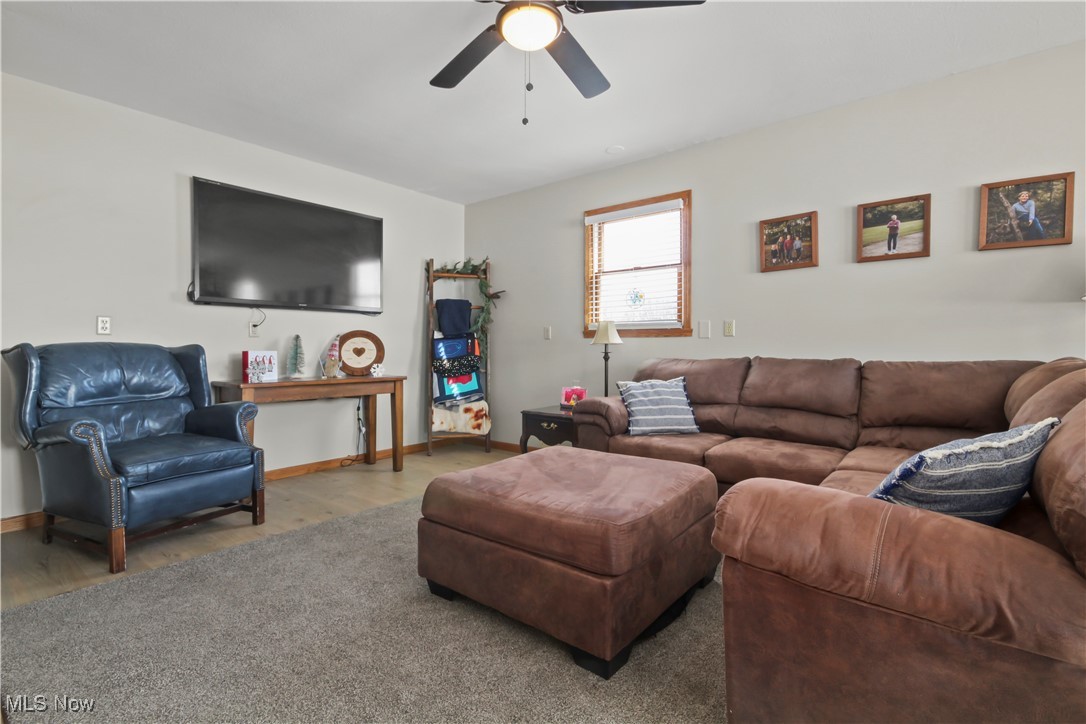 28196 Hartley Road Beloit, OH 44609 - Photo 9 of 27 Carpeted living room featuring a ceiling fan and baseboards