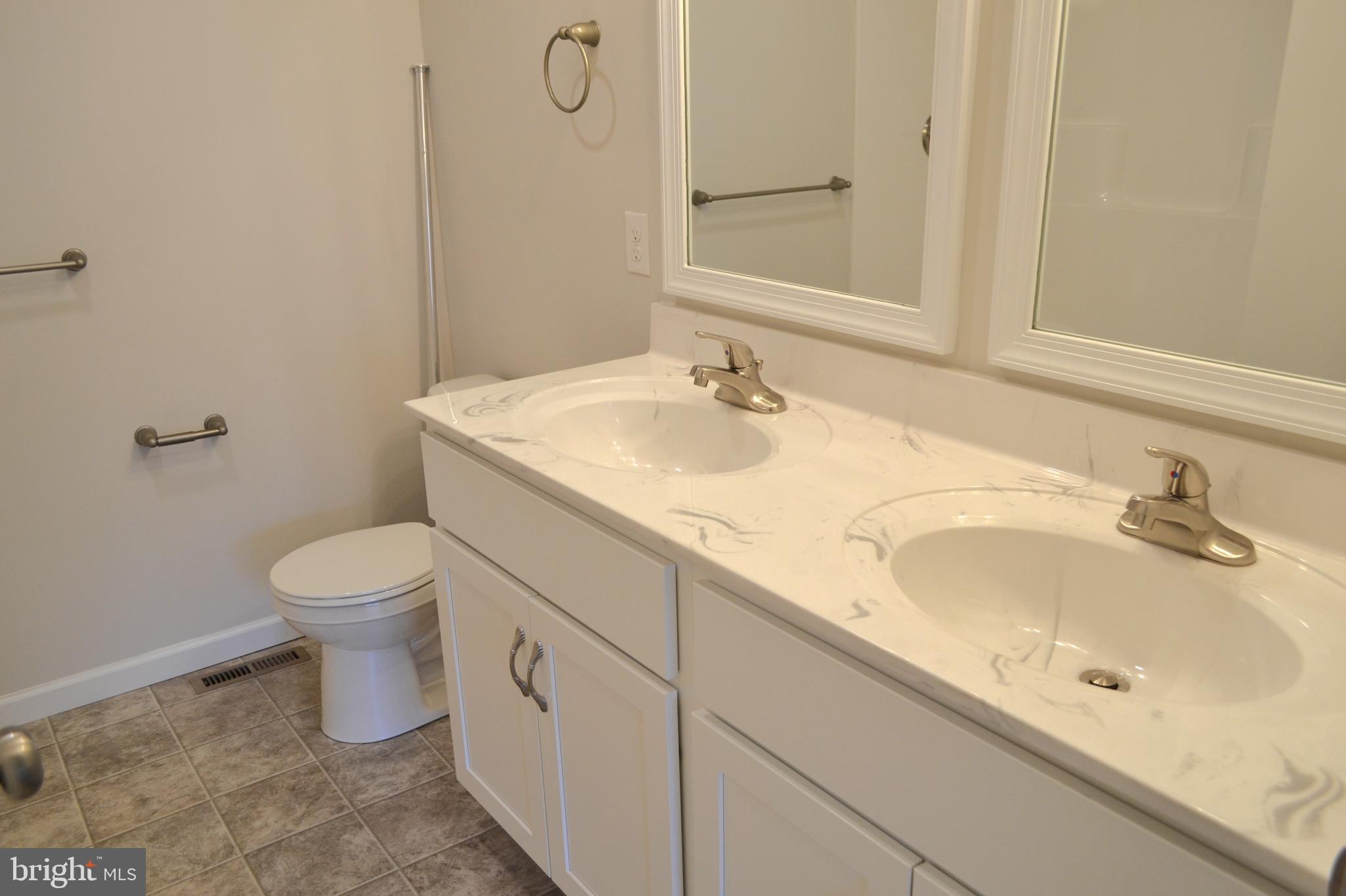 4148 Sefranka Road, Unit (LOT 2) Temple, PA 19560 - Photo 10 of 13 a bathroom with a toilet sink and mirror