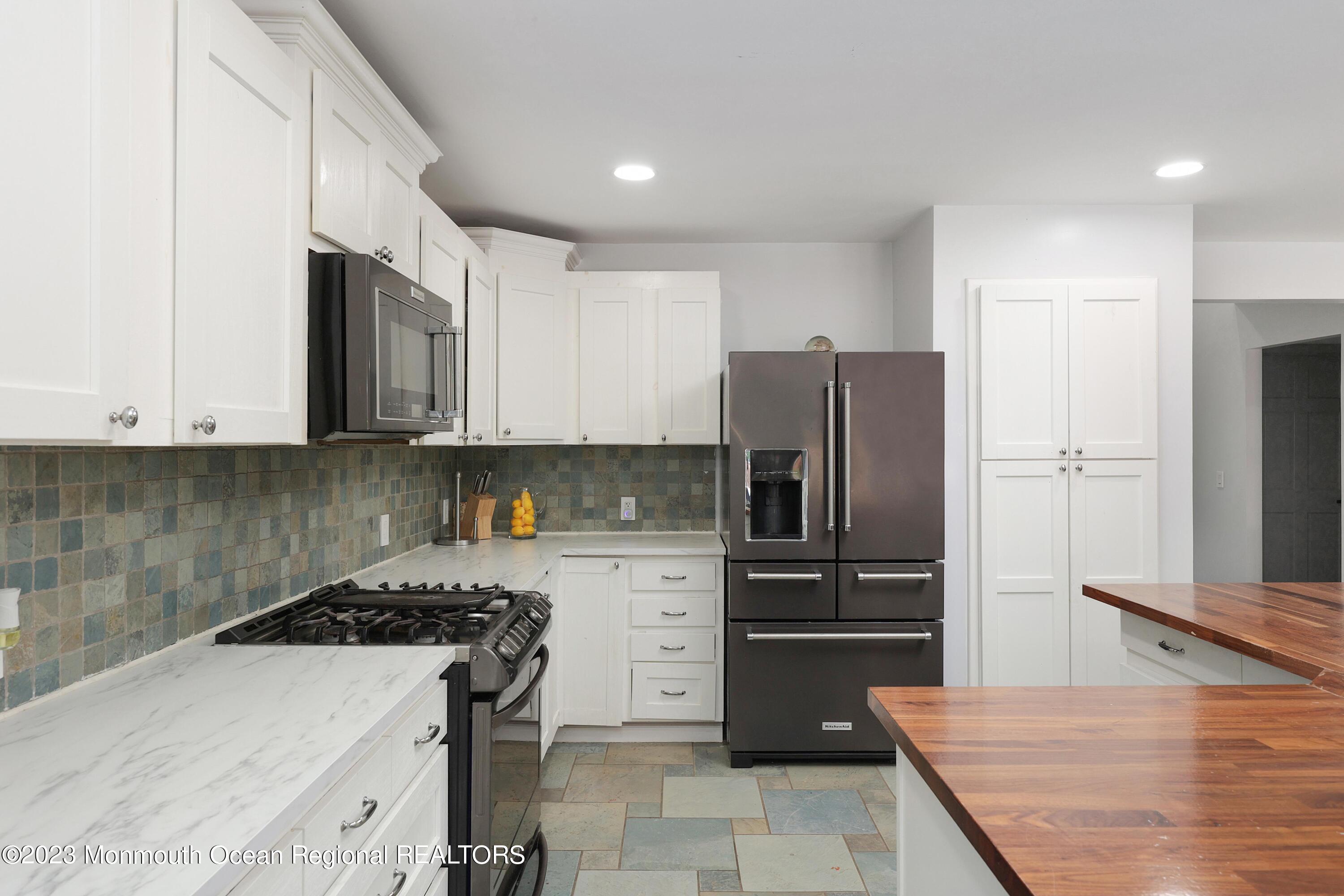 2450 Capshaw Road Forked River, NJ 08731 - Photo 13 of 37 a kitchen with stainless steel appliances granite countertop a refrigerator and a stove top oven