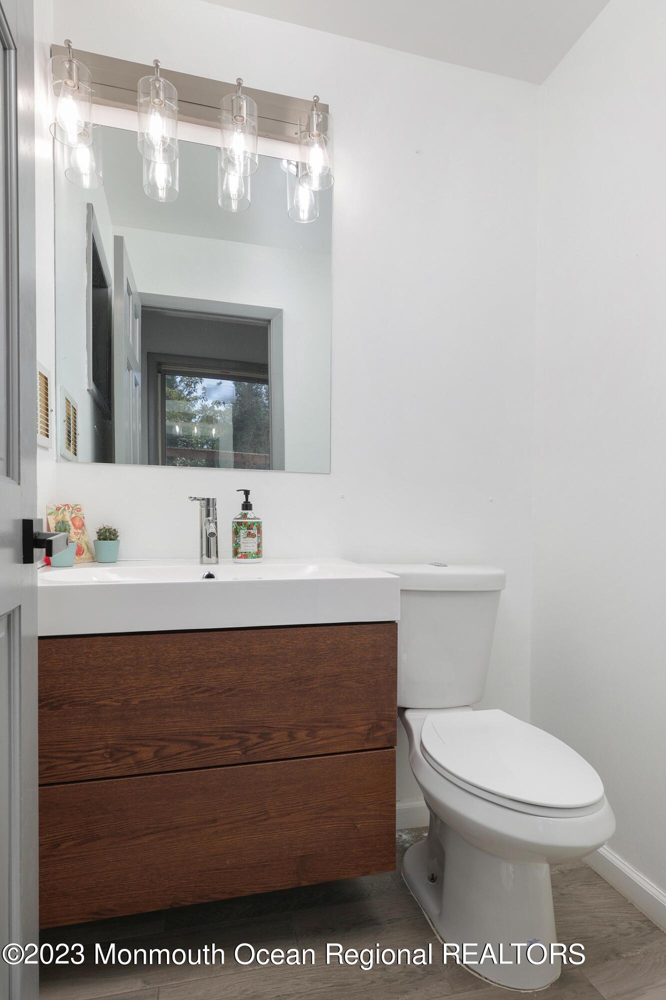 2450 Capshaw Road Forked River, NJ 08731 - Photo 18 of 37 a bathroom with a toilet a sink and mirror