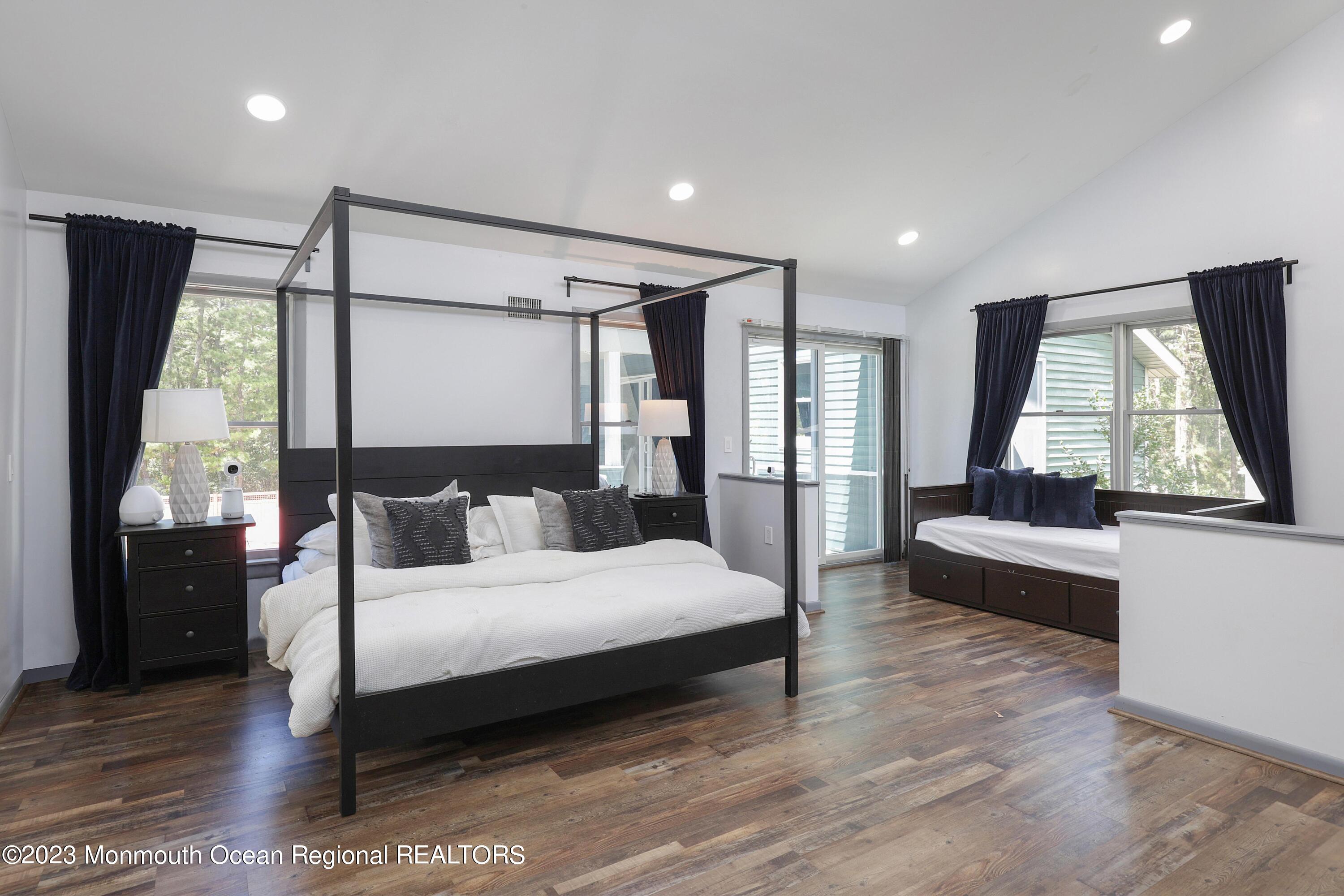 2450 Capshaw Road Forked River, NJ 08731 - Photo 19 of 37 a bedroom with a large bed and a large window