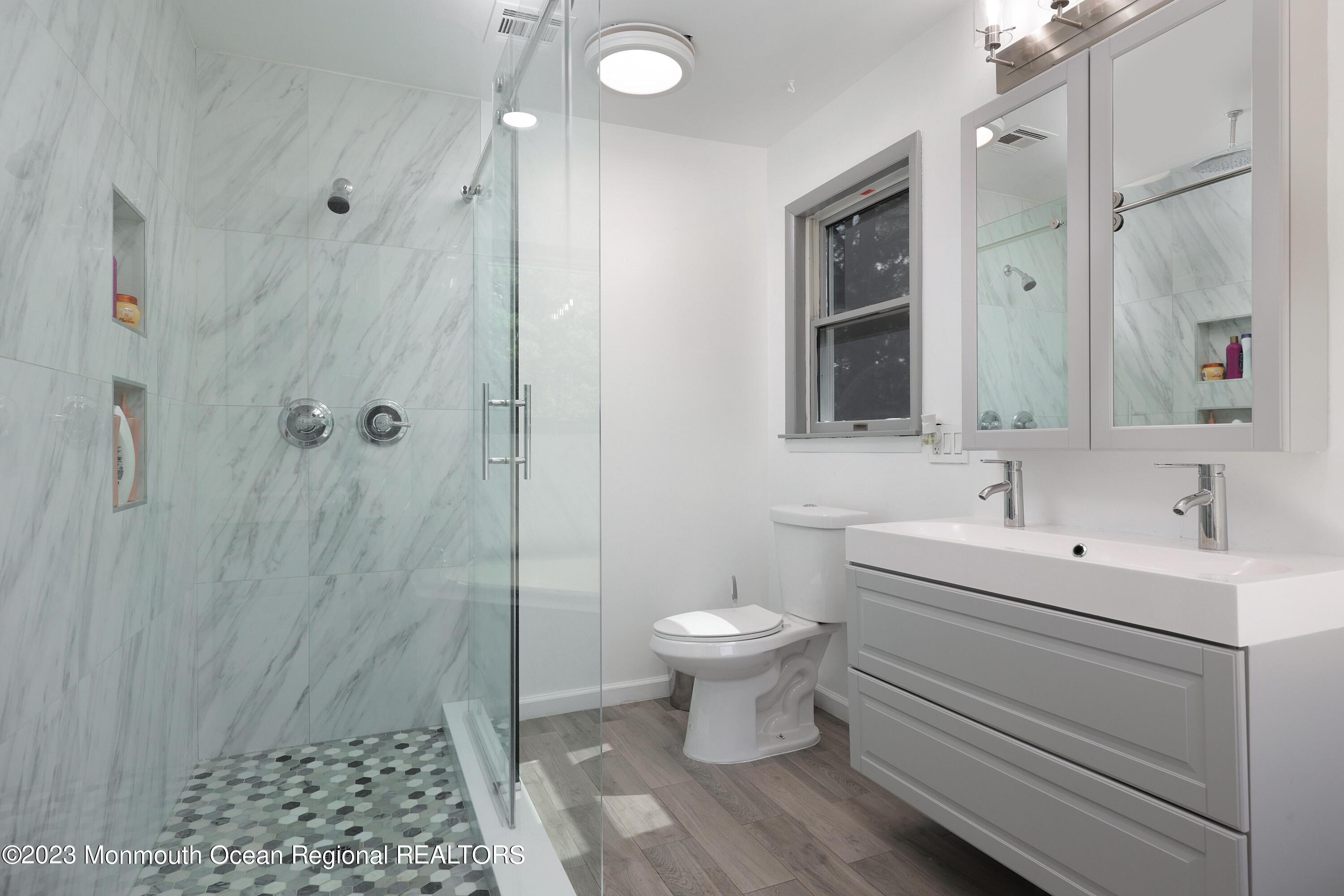 2450 Capshaw Road Forked River, NJ 08731 - Photo 21 of 37 a bathroom with a sink toilet a mirror and shower