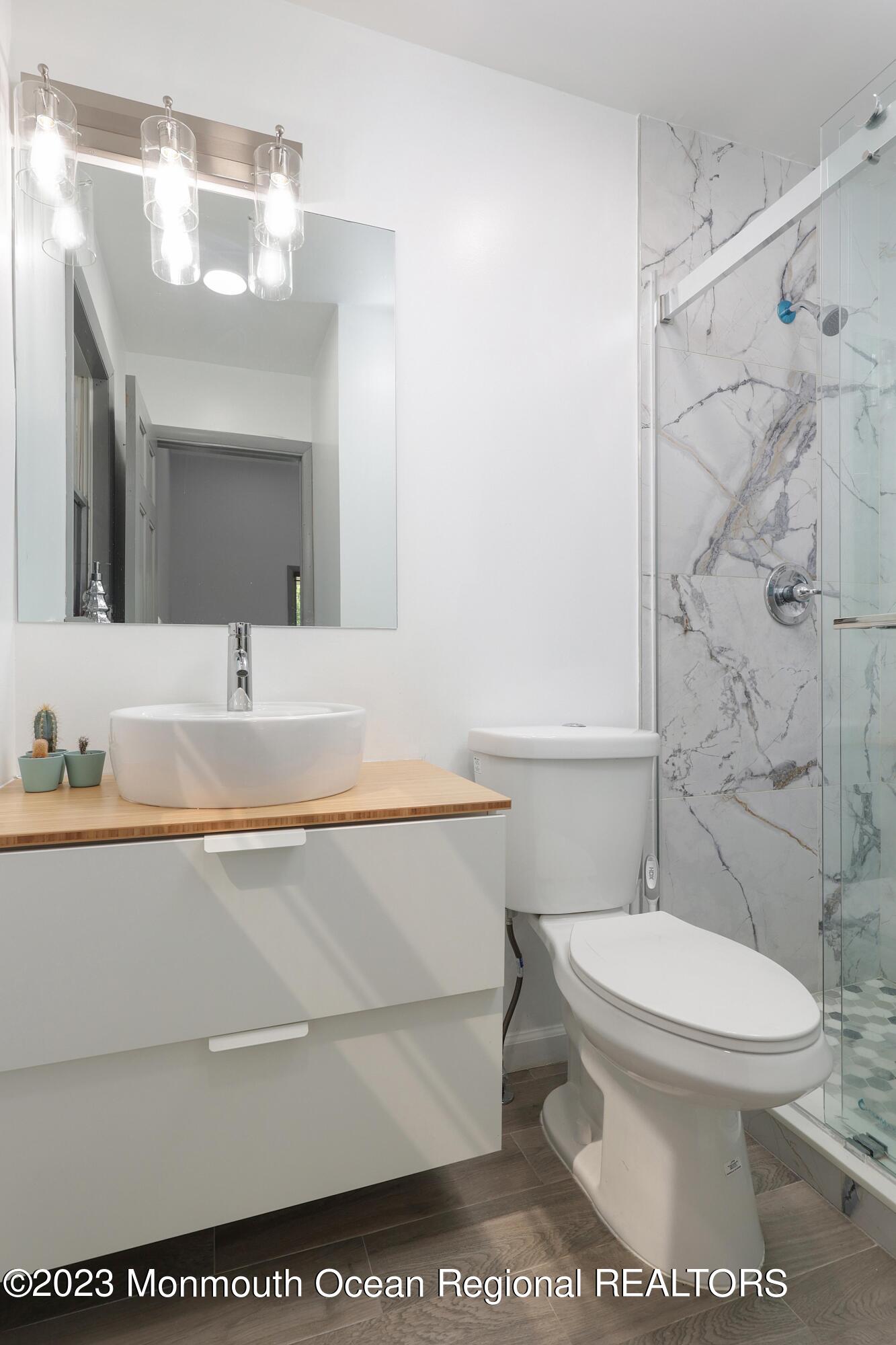 2450 Capshaw Road Forked River, NJ 08731 - Photo 23 of 37 a bathroom with a sink a toilet and a mirror
