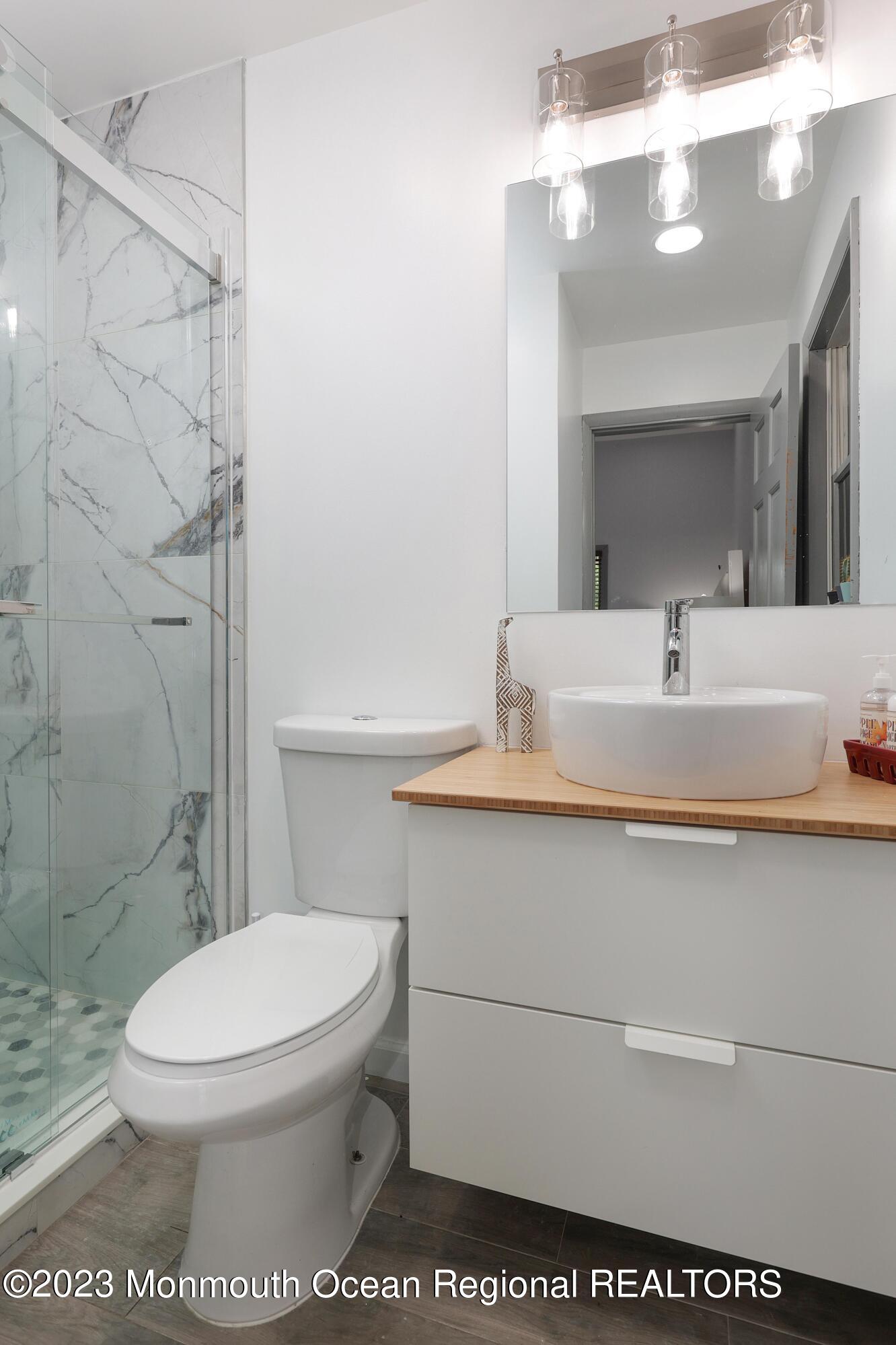 2450 Capshaw Road Forked River, NJ 08731 - Photo 25 of 37 a bathroom with a sink a toilet and shower