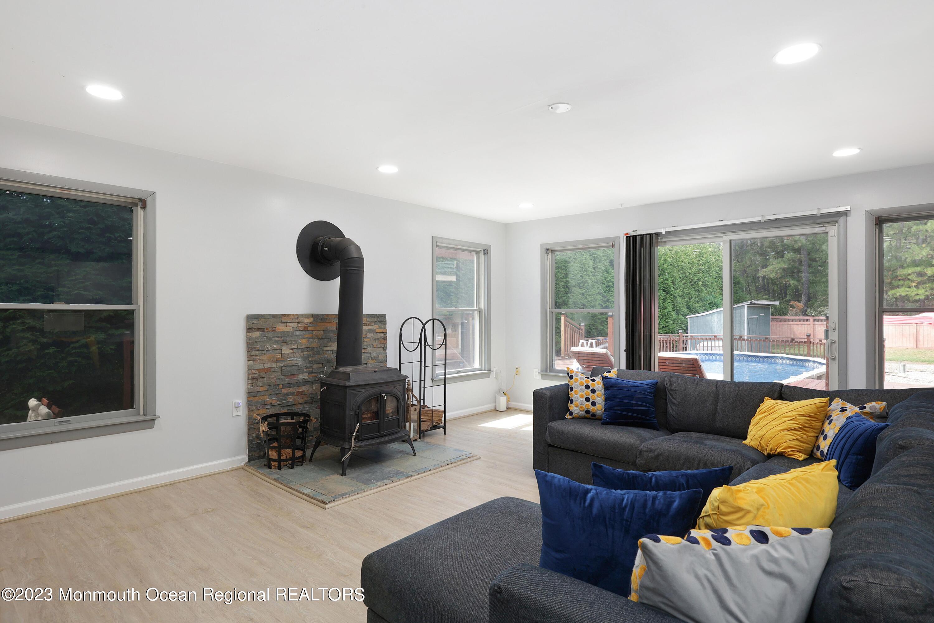 2450 Capshaw Road Forked River, NJ 08731 - Photo 26 of 37 a living room with furniture and a fireplace