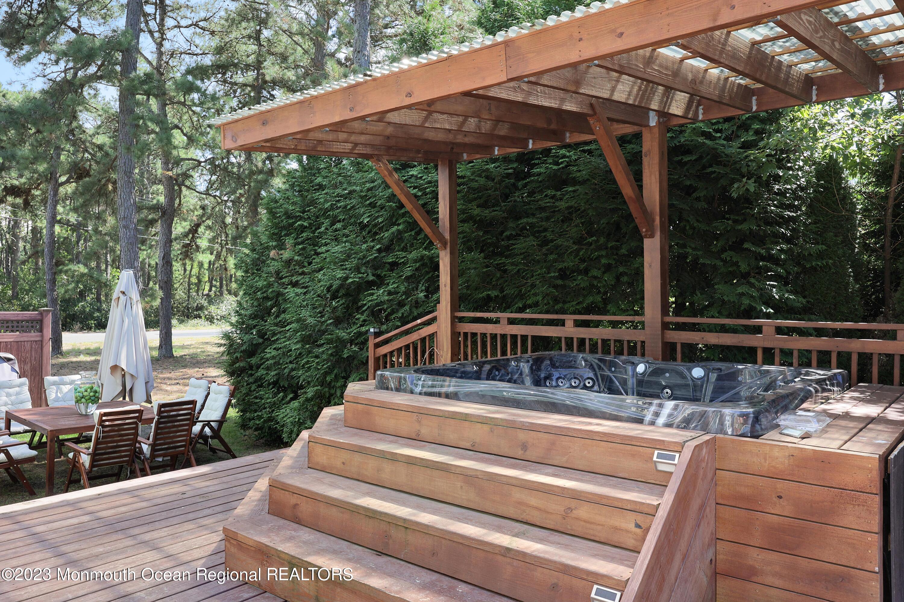 2450 Capshaw Road Forked River, NJ 08731 - Photo 32 of 37 a view of a patio with table and chairs under an umbrella