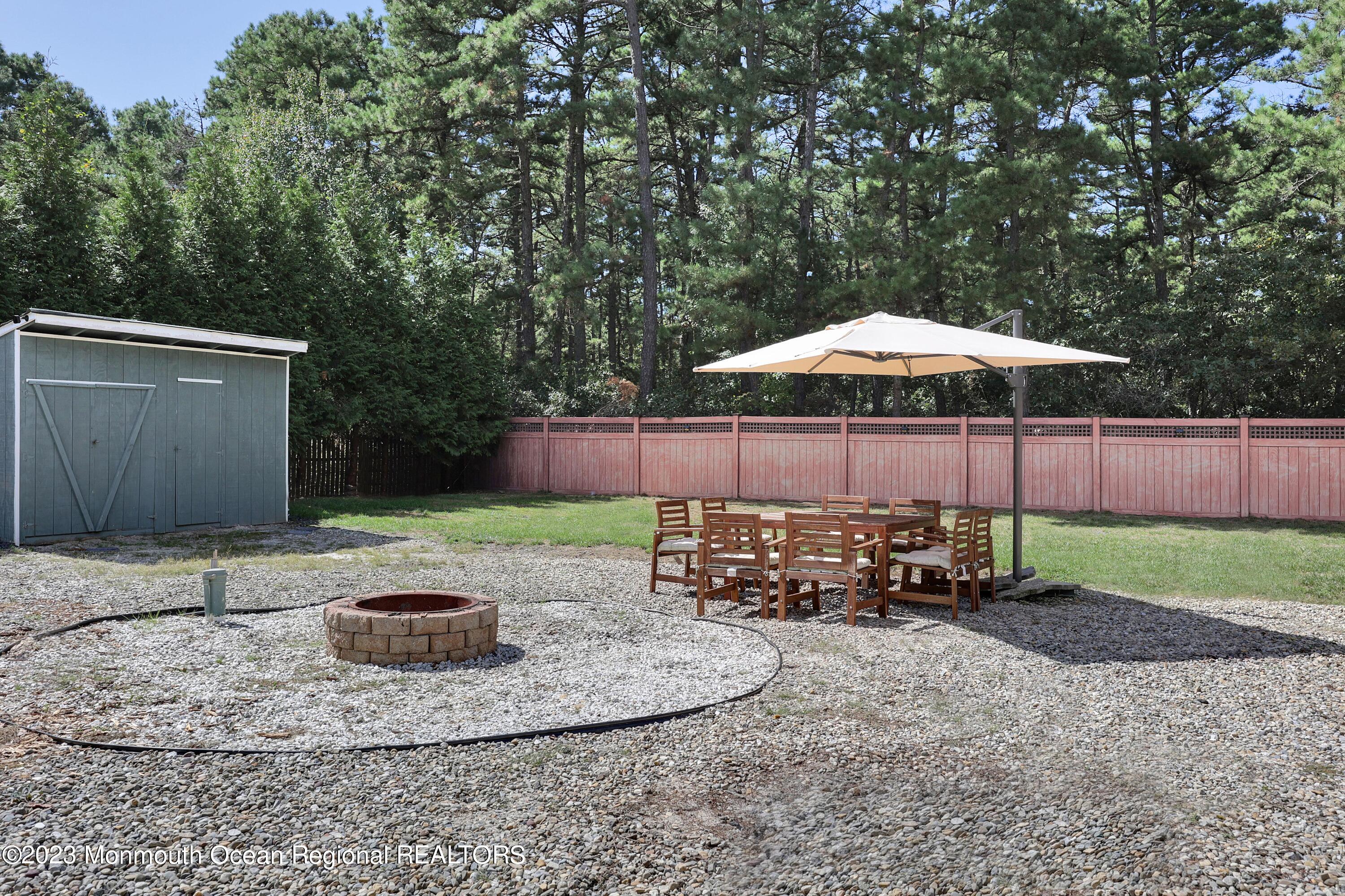 2450 Capshaw Road Forked River, NJ 08731 - Photo 34 of 37 a backyard of a house with barbeque oven and outdoor seating