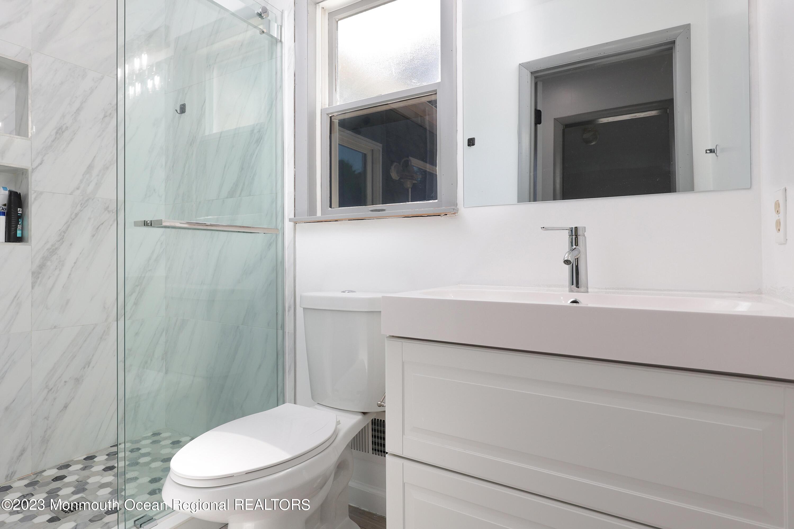 2450 Capshaw Road Forked River, NJ 08731 - Photo 4 of 37 a bathroom with a sink a toilet and shower