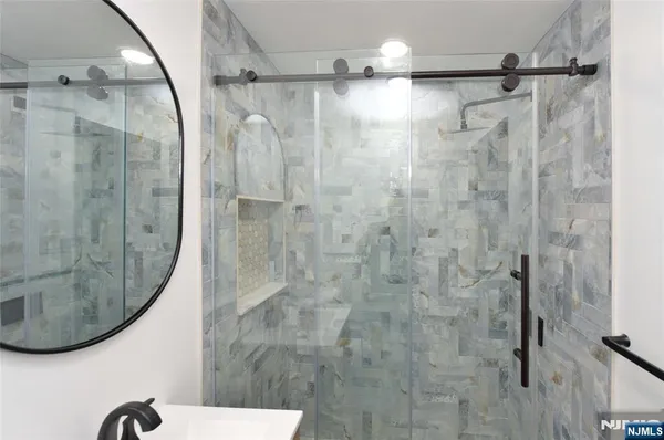 a bathroom with a shower and a mirror