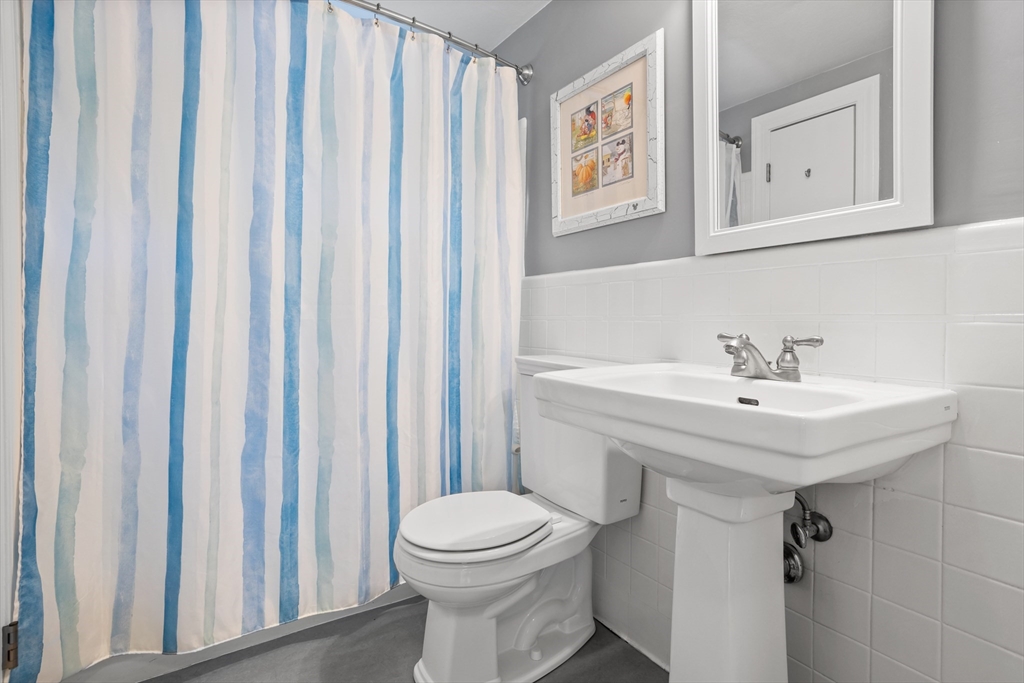 32 Melvin Road Arlington, MA 02474 - Photo 17 of 39 a bathroom with a sink a toilet and a mirror