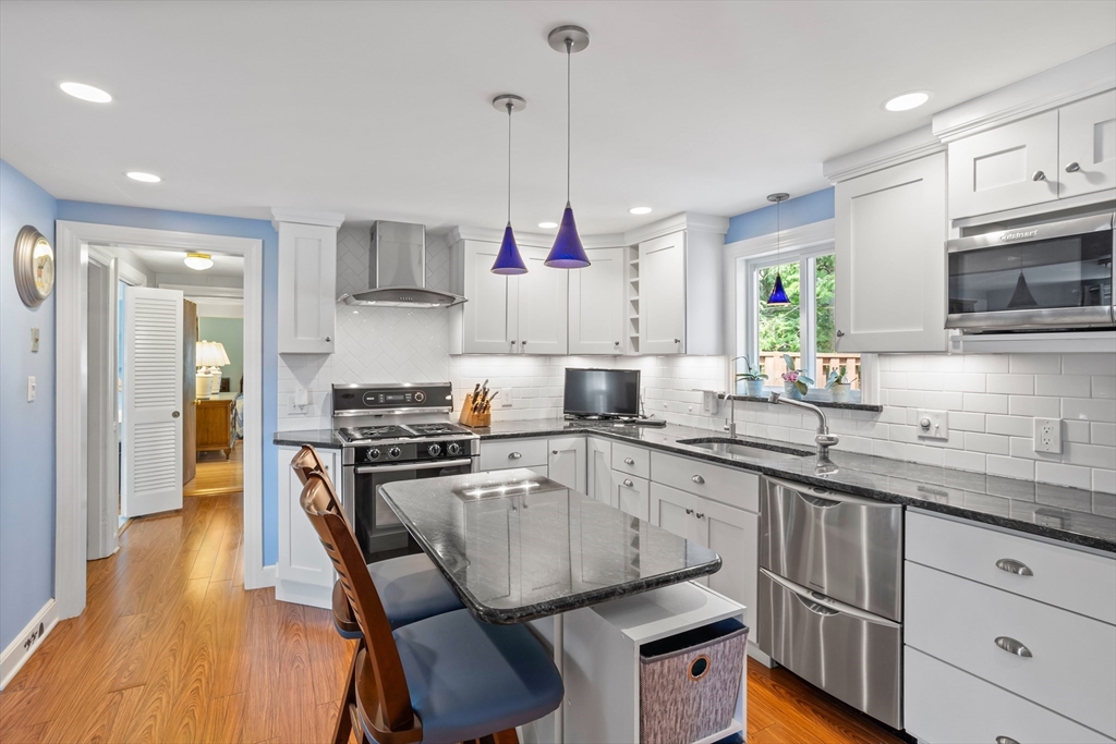 32 Melvin Road Arlington, MA 02474 - Photo 4 of 39 a kitchen with a sink stove and refrigerator