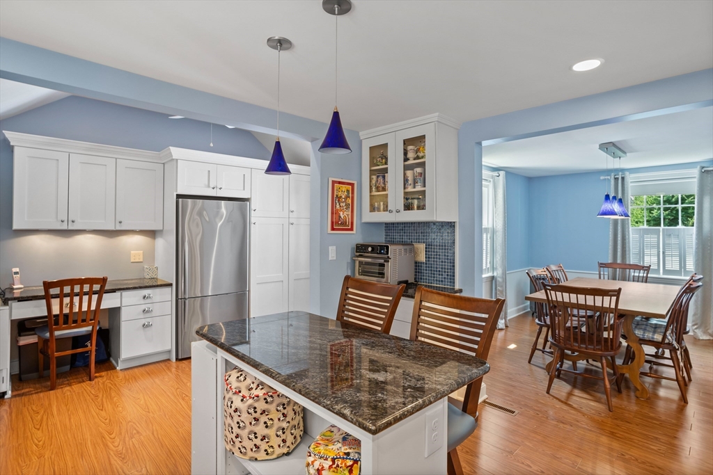 32 Melvin Road Arlington, MA 02474 - Photo 6 of 39 a kitchen with granite countertop a table chairs and a refrigerator