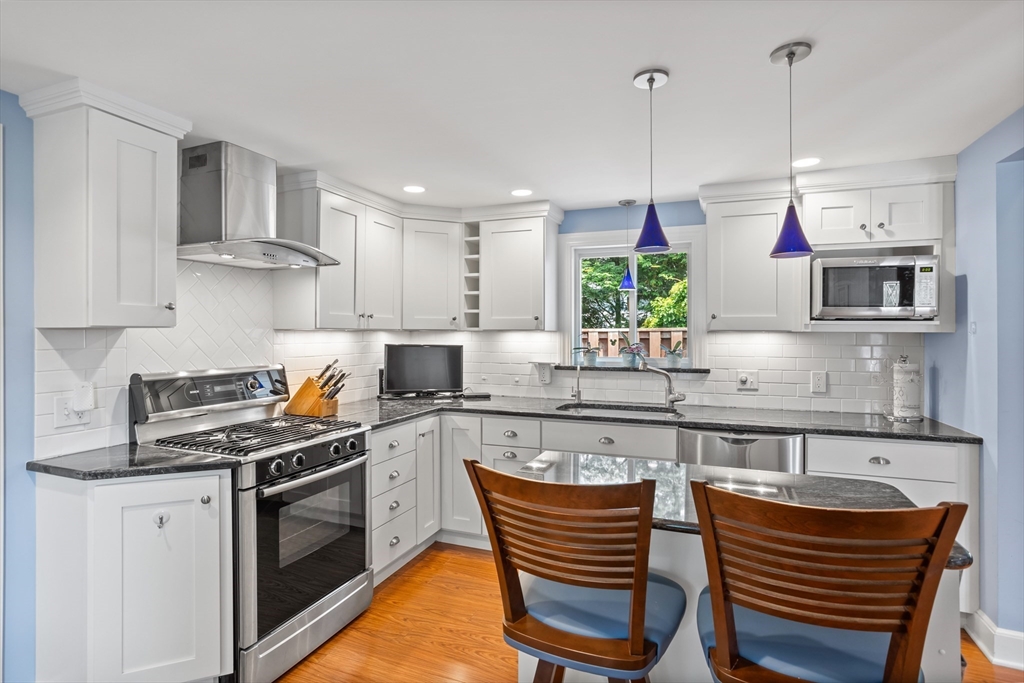 32 Melvin Road Arlington, MA 02474 - Photo 7 of 39 a kitchen with stainless steel appliances granite countertop a stove a sink and a refrigerator