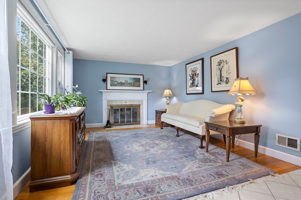 32 Melvin Road Arlington, MA 02474 - Photo 9 of 39 a living room with furniture a window and a fireplace