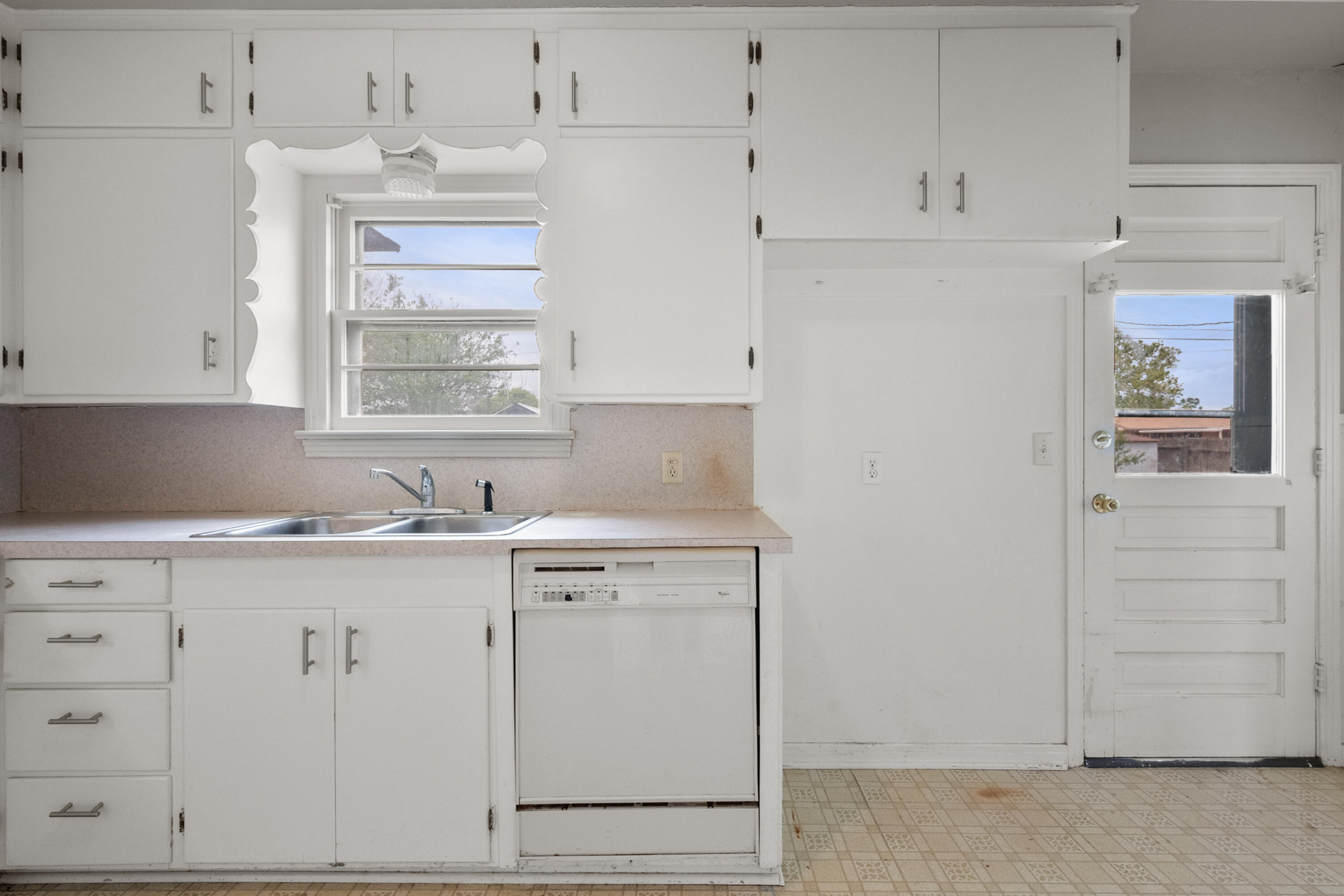 811 Zephyr Plainview, TX 79072 - Photo 15 of 25 a kitchen with cabinets appliances a sink and a window