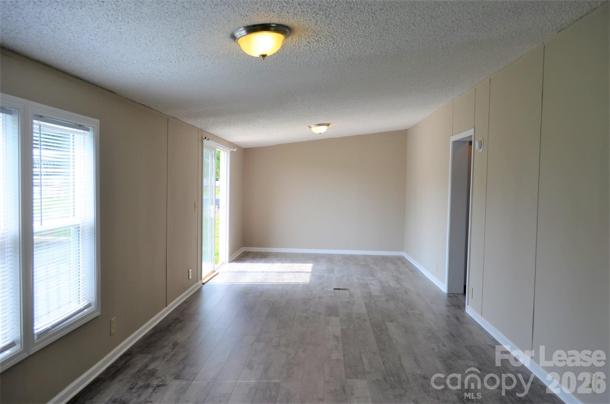 7167 Long Island Road Catawba, NC 28609 - Photo 14 of 34 an empty room with wooden floor and windows