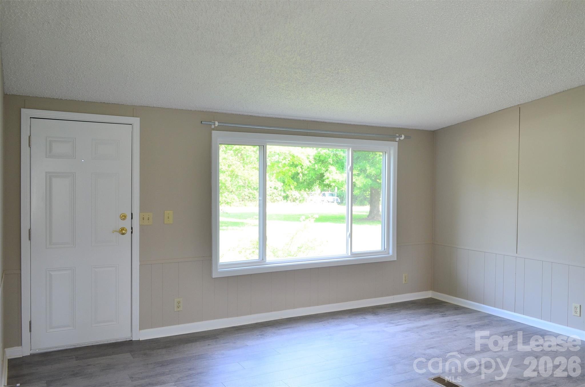 7167 Long Island Road Catawba, NC 28609 - Photo 3 of 34 an empty room with wooden floor and windows