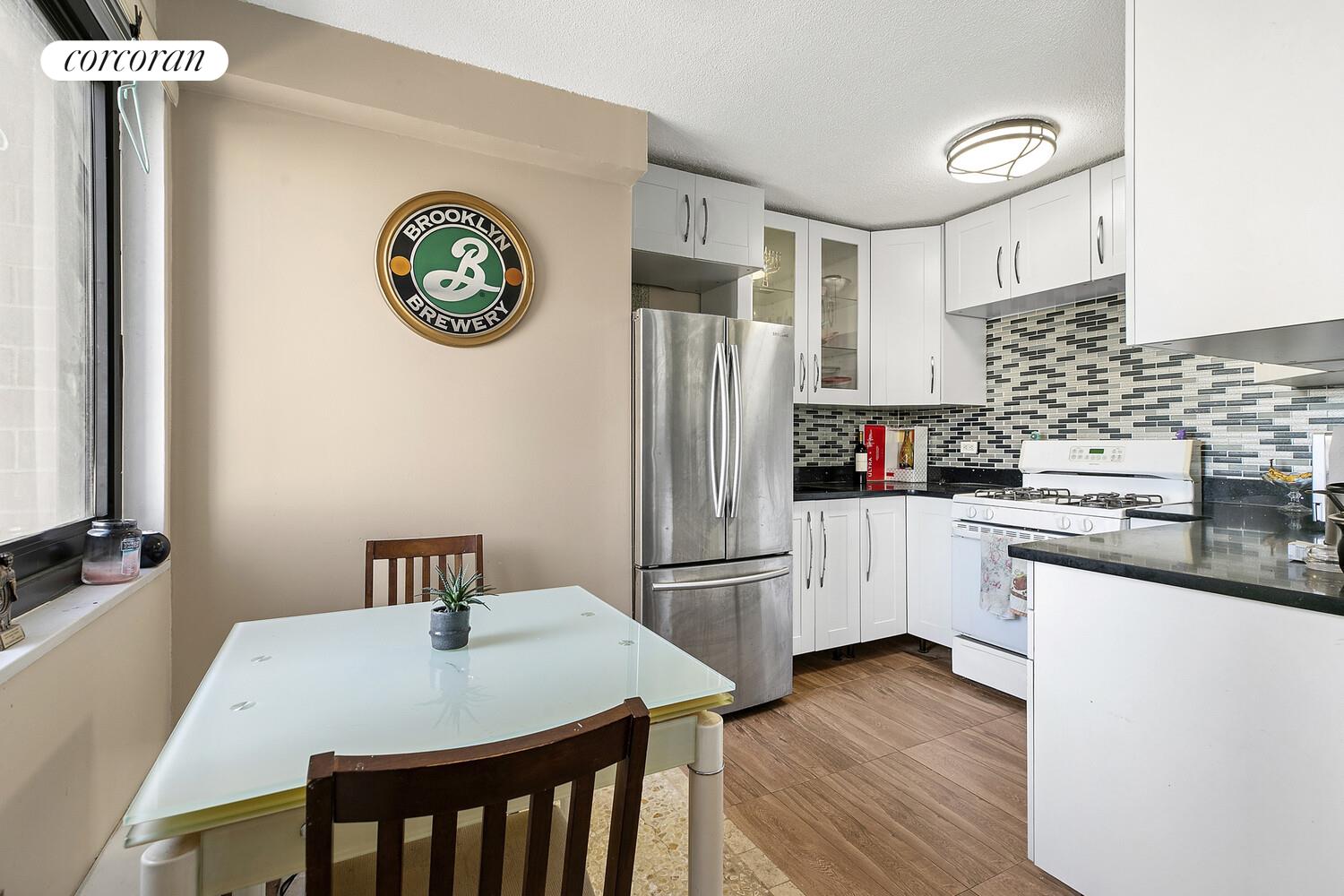 a kitchen with stainless steel appliances granite countertop a refrigerator and a stove top oven