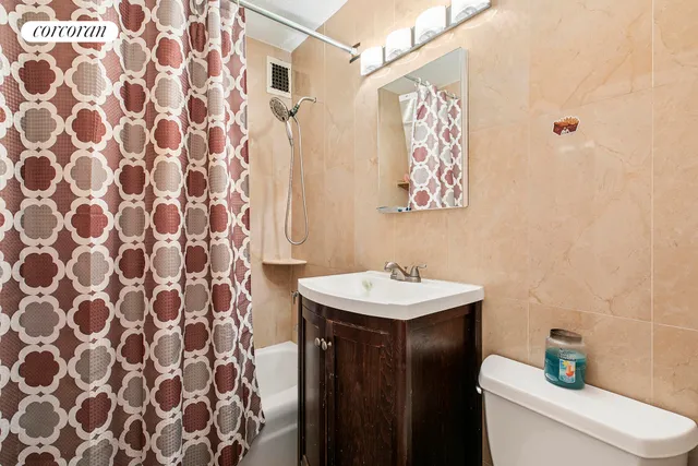 a bathroom with a sink and mirror with toilet