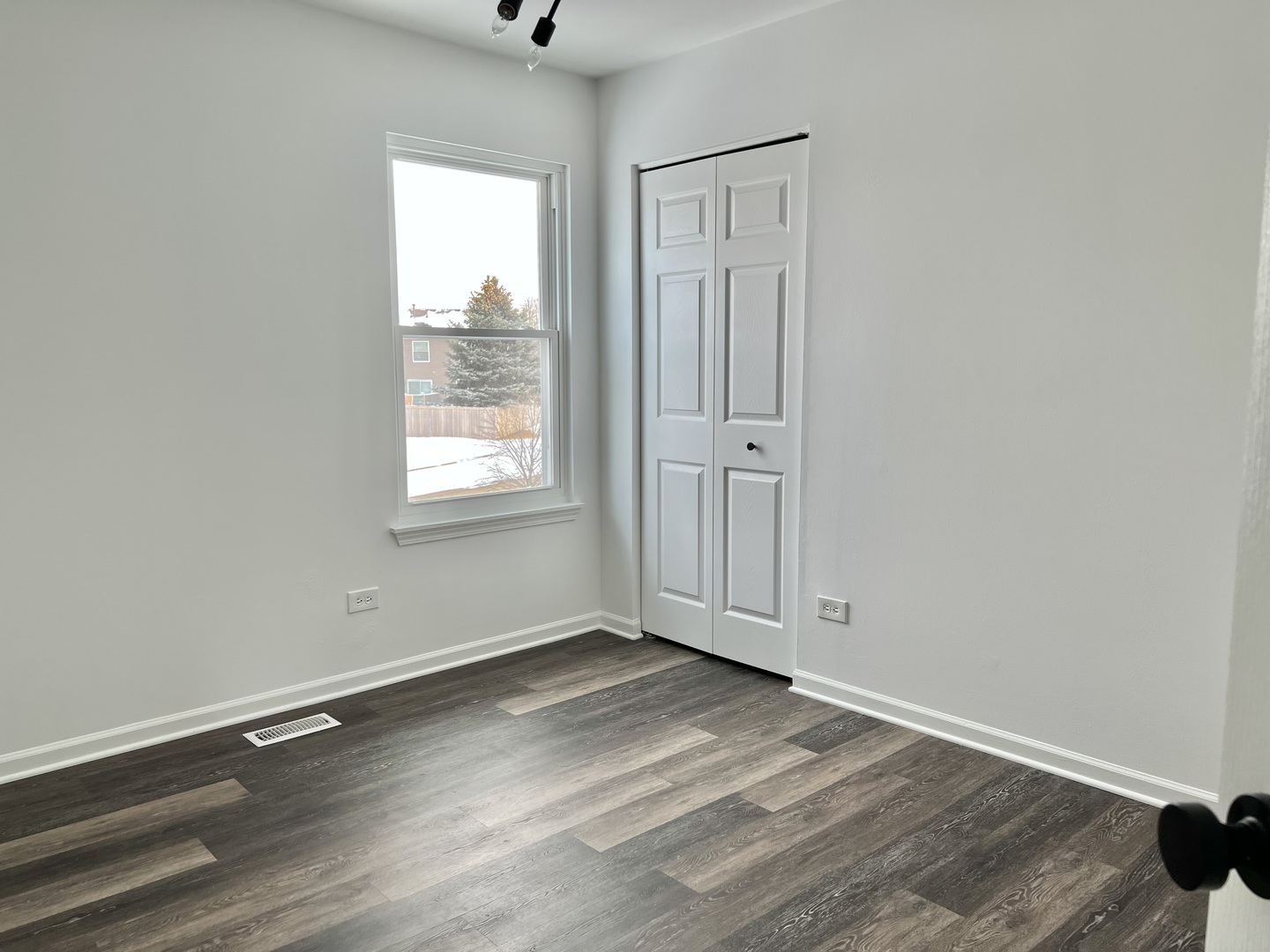621 Buckboard Road Bolingbrook, IL 60490 - Photo 23 of 38 an empty room with wooden floor and windows