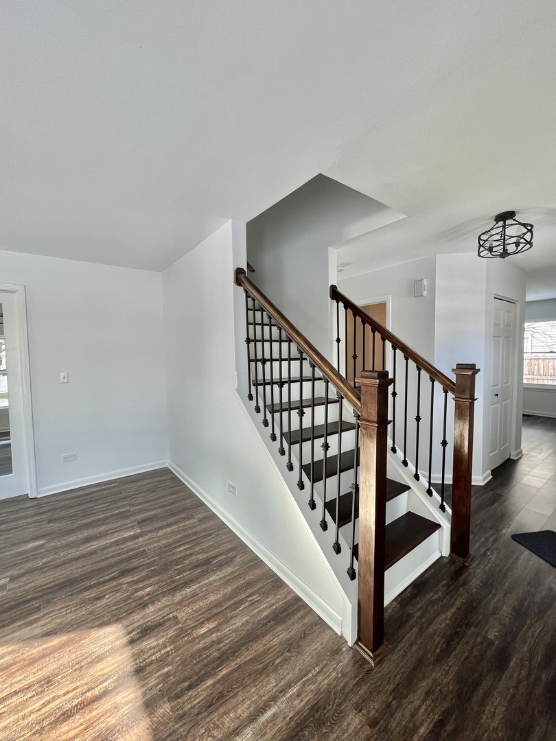 621 Buckboard Road Bolingbrook, IL 60490 - Photo 5 of 38 a view of a hallway with wooden floor and staircase