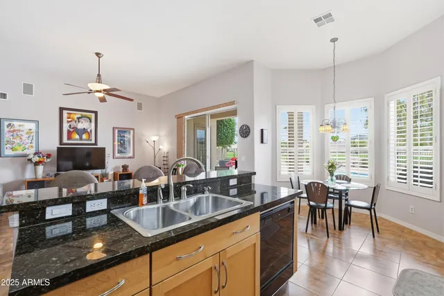 a kitchen with granite countertop wooden cabinets and a stove top oven