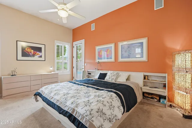a spacious bedroom with a bed and a chandelier