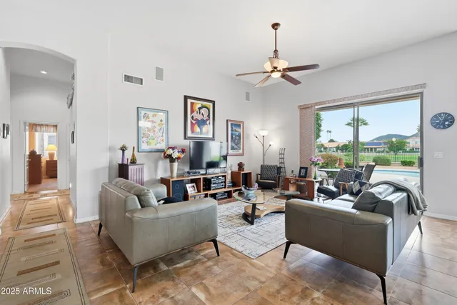 a living room with furniture a fireplace and a chandelier