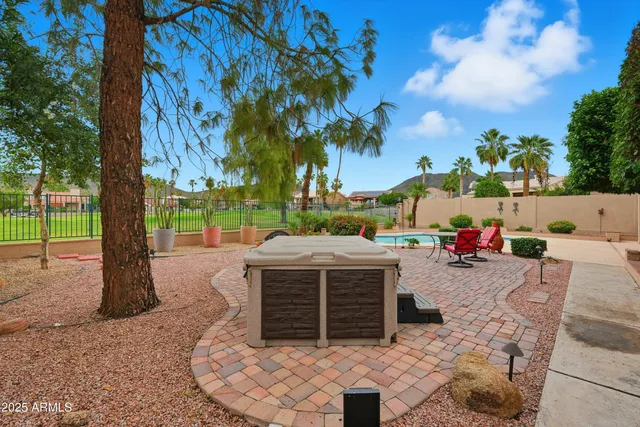 an aerial view of residential houses with outdoor space and trees