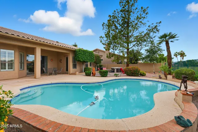 an aerial view of residential houses with outdoor space and trees