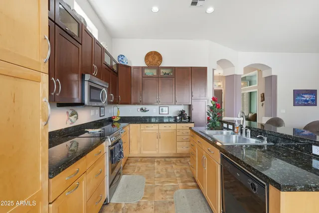 a view of a house with a yard and potted plants