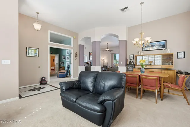 a dining room with furniture and chandelier