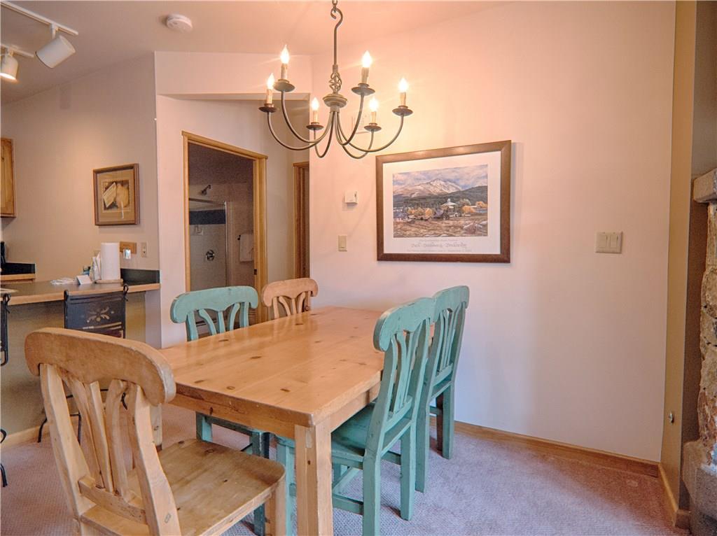 129 River Run Road, Unit 8064 Keystone, CO 80435 - Photo 4 of 21 a view of a dining room with furniture and wooden floor