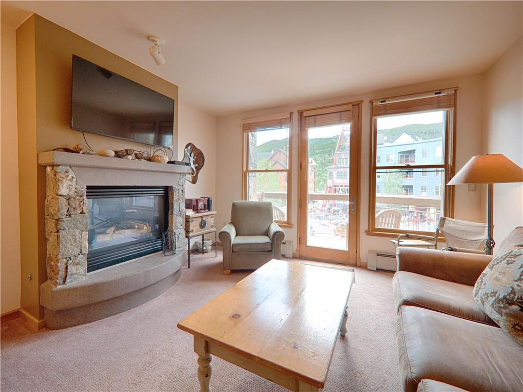 129 River Run Road, Unit 8064 Keystone, CO 80435 - Photo 6 of 21 a living room with furniture a flat screen tv and a fireplace
