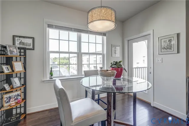 a dining room with furniture a book and wooden floor