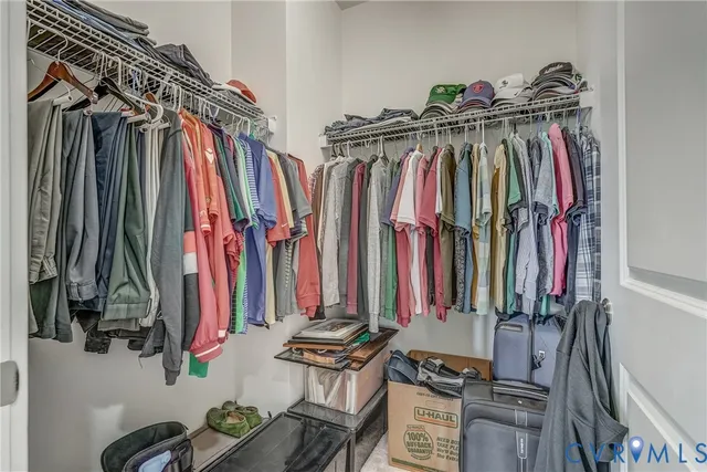 a view of walk in closet with clothes
