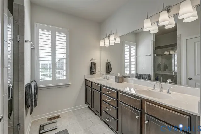 a bathroom with double sink and a mirror