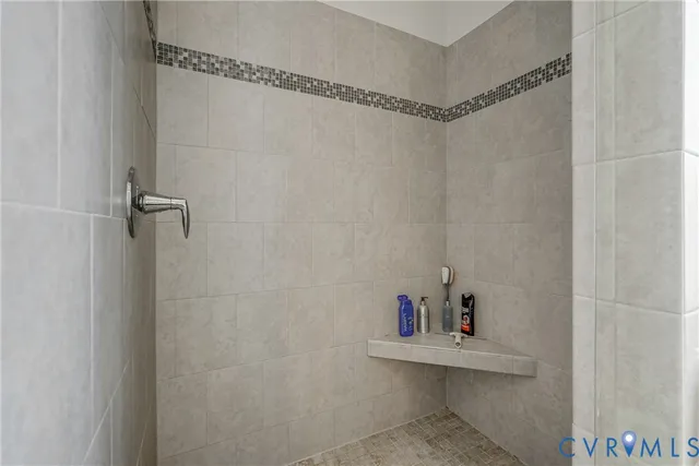 a bathroom with a sink a mirror and shower