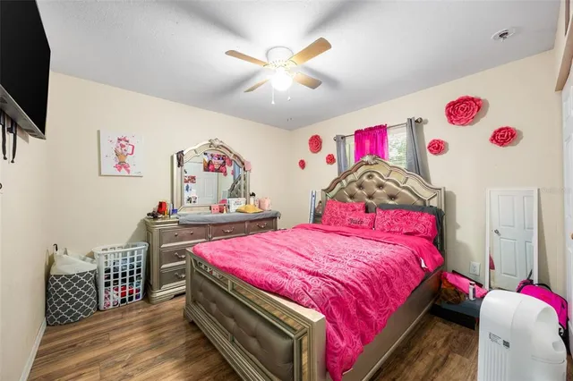 a bedroom with a bed and a white wall painting