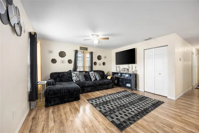 a living room with furniture and a flat screen tv