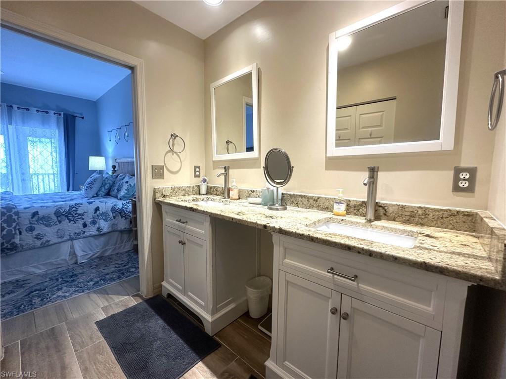 470 Launch Circle, Unit V503 Naples, FL 34108 - Photo 11 of 30 a bathroom with a sink and a mirror