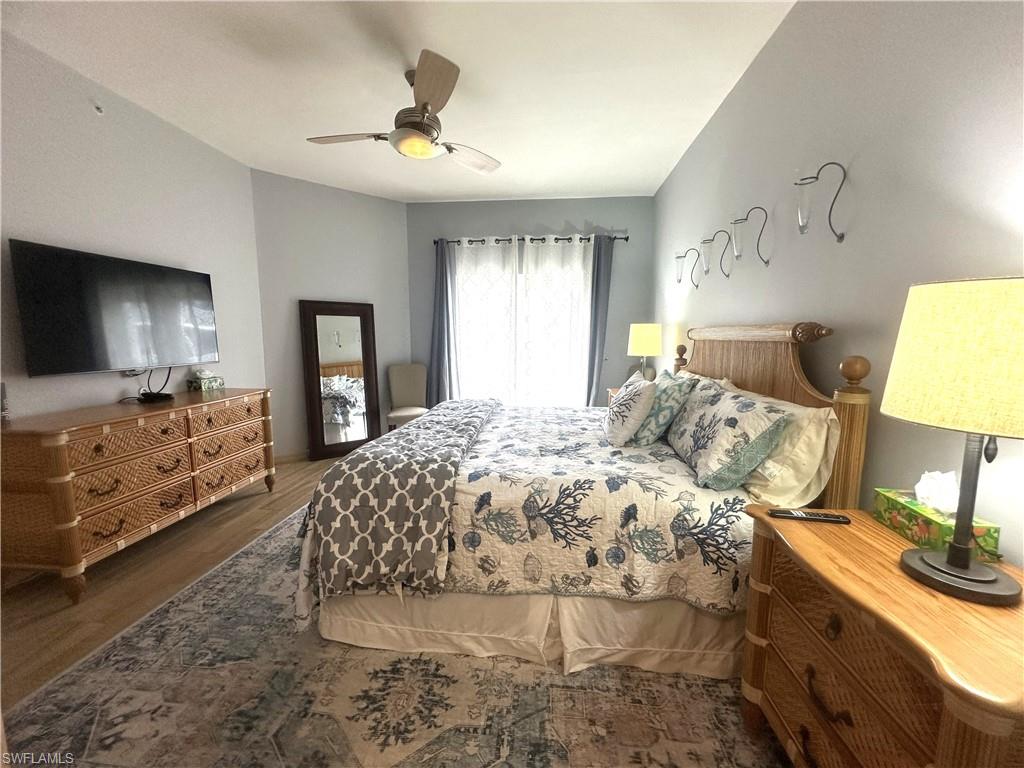 470 Launch Circle, Unit V503 Naples, FL 34108 - Photo 12 of 30 a bedroom with a bed and a flat screen tv