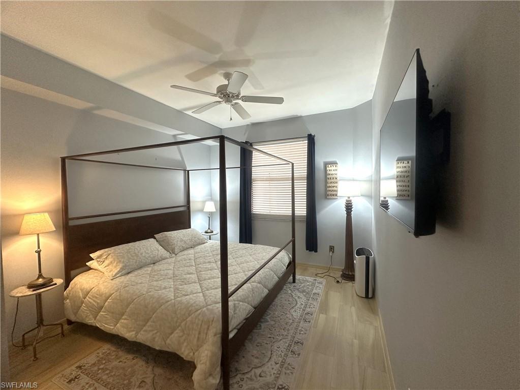 470 Launch Circle, Unit V503 Naples, FL 34108 - Photo 17 of 30 a bedroom with a bed and a chandelier