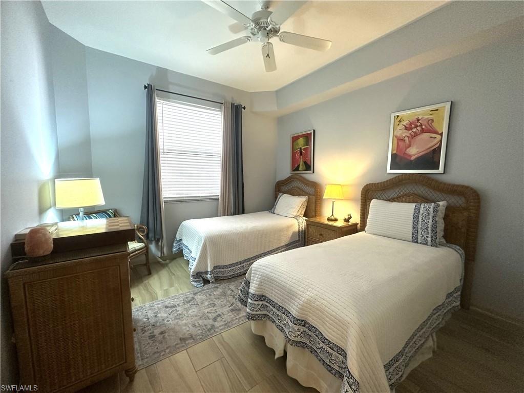 470 Launch Circle, Unit V503 Naples, FL 34108 - Photo 19 of 30 a bedroom with two beds and two windows