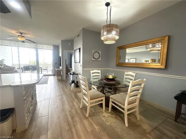 a view of a dining room with furniture wooden floor and chandelier