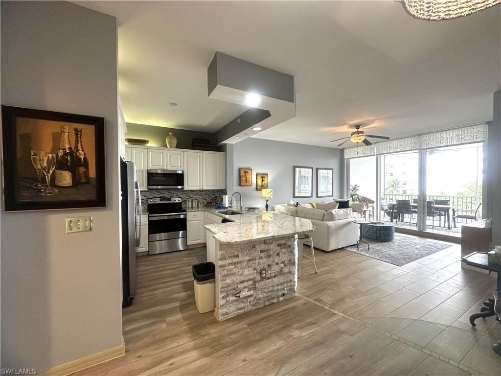 470 Launch Circle, Unit V503 Naples, FL 34108 - Photo 5 of 30 a living room with lots of furniture and view kitchen