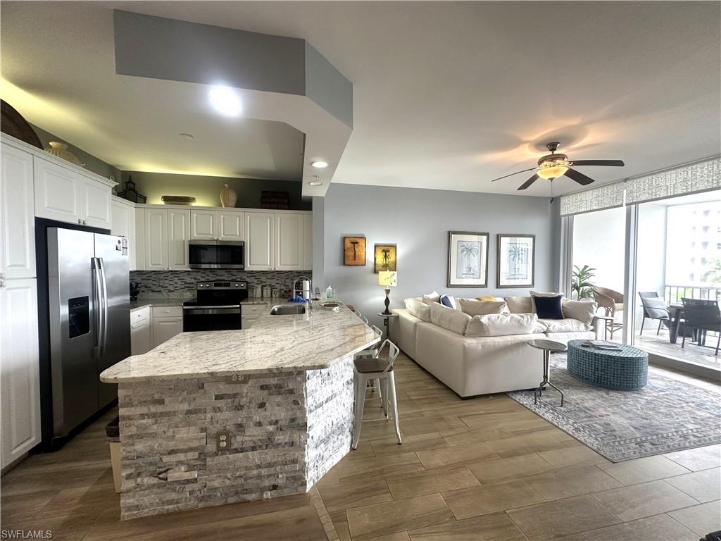 470 Launch Circle, Unit V503 Naples, FL 34108 - Photo 6 of 30 a large kitchen with stainless steel appliances kitchen island granite countertop a refrigerator stove and sink